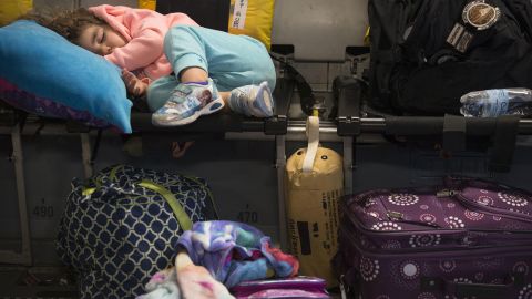 Amelia McNab, 2, sleeps inside a military transport plane Friday, April 1, at Baltimore-Washington International Airport. The U.S. military <a href="http://www.cnn.com/2016/03/29/politics/pentagon-orders-military-families-to-leave-southern-turkey/" target="_blank">ordered military family members</a> to evacuate southern Turkey because of security concerns, the Pentagon said. A U.S. official said the evacuation was made because of the ongoing threats concerning possible ISIS attacks.
