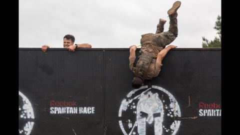 Army soldiers climb over an 8-foot wall in Fort Mitchell, Alabama, as they take park in the 33rd annual Best Ranger Competition on Saturday, April 16. The three-day event tested competitors' physical, mental and technical capabilities. 