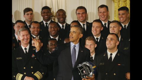 U.S. President Barack Obama looks at a ring that was given to him by the Navy football team on Wednesday, April 27. The team was at the White House to receive the Commander-in-Chief's Trophy, which is awarded annually to the winner of the college football series between Navy, Army and Air Force.