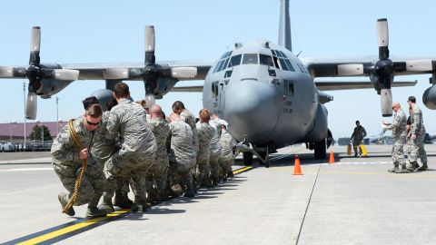 Members of the 374th Maintenance Squadron pull a C-130 Hercules at Yokota Air Base in Japan on Friday, April 15. It was part of a Maintenance Rodeo Competition that pits squadrons against one another.