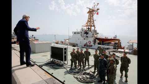 U.S. Secretary of State John Kerry talks with members of the Coast Guard as he tours a base in Manama, Bahrain, on Thursday, April 7.