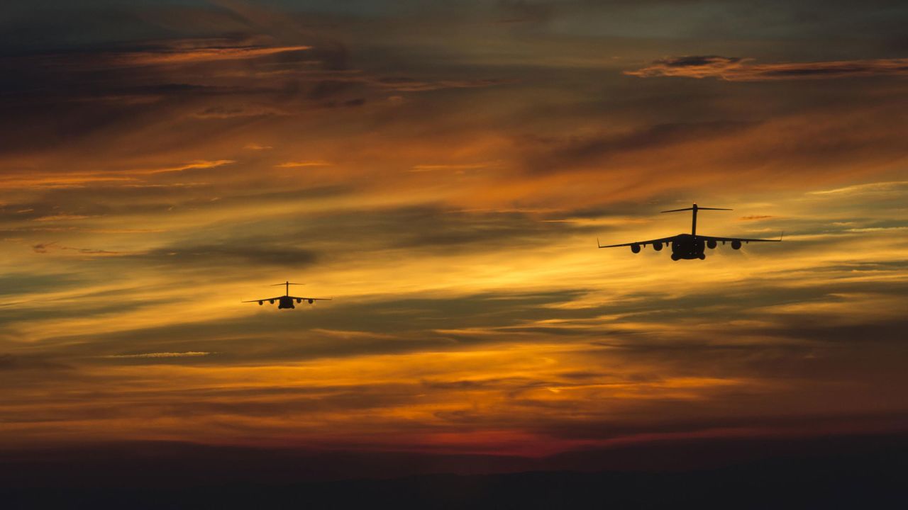 Two military transport planes prepare to drop soldiers during a tactical exercise in Fort Bragg, North Carolina, on Friday, April 15.