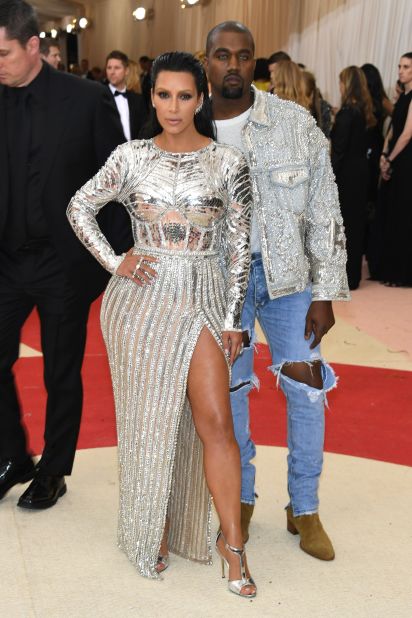  Kim Kardashian West is pictured here with husband Kanye West. The pair are both wearing outfits by Balmain, which Kanye West accessorized with blue contact lenses. 