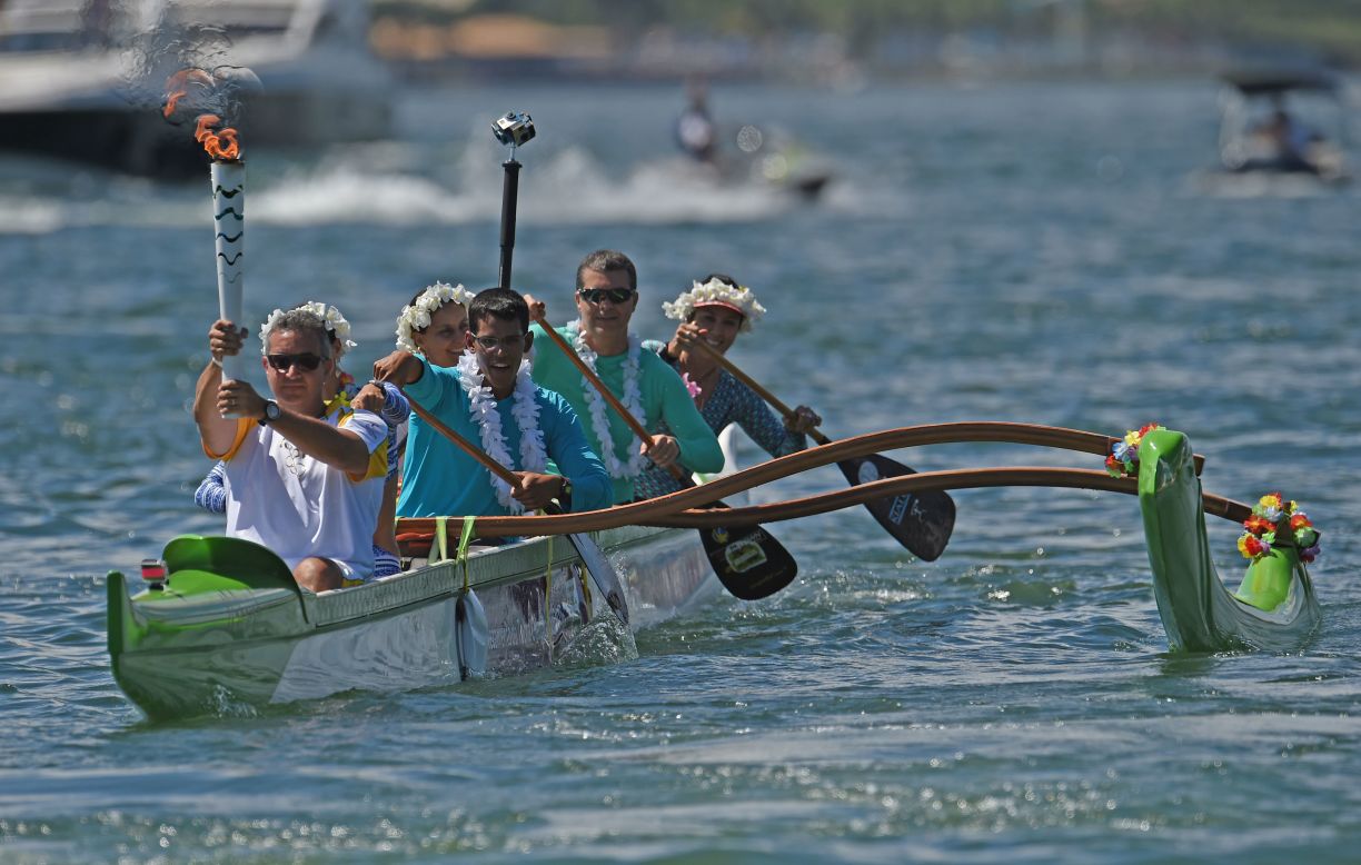 Canoeist Rubens Pompeu carried the Olympic flame on an outrigger canoe at Lake Paranoa. The torch will be carried in a relay by 12,000 people throughout its journey across the country.<br />