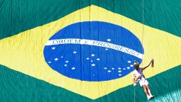 Brazilian fireman Haudson Alves descends from a helicopter carrying the Olympic flame on a lantern at the Brasilia National Stadium in Brasilia on May 3, 2016.
Embattled President Dilma Rousseff greeted the Olympic flame in Brazil on Tuesday, promising not to allow a raging political crisis, which could see her suspended within days, to spoil the Rio Games. The torch will now be carried in a relay by 12,000 people through 329 cities, ending in Rio's Maracana stadium on August 5 for the opening ceremony.        / AFP / BETO BARATA        (Photo credit should read BETO BARATA/AFP/Getty Images)