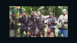 A screengrab from a video obtained by extremist monitoring organization SITE purportedly shows three hostages held by Abu Sayyaf.