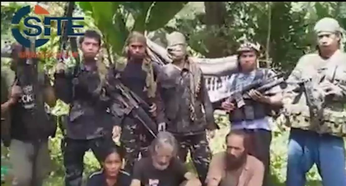 A screengrab from a video obtained by extremist monitoring organization SITE purportedly shows three hostages held by Abu Sayyaf.