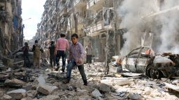 TOPSHOT - People walk amid the rubble of destroyed buildings following a reported air strike on the rebel-held neighbourhood of al-Kalasa in the northern Syrian city of Aleppo, on April 28, 2016.
The death toll from an upsurge of fighting in Syria's second city Aleppo rose despite a plea by the UN envoy for the warring sides to respect a February ceasefire. / AFP / AMEER ALHALBI        (Photo credit should read AMEER ALHALBI/AFP/Getty Images)