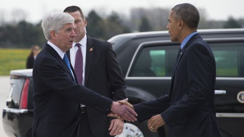 President Barack Obama shakes hands with Michigan Governor Rick Snyder upon his arrival in Flint, Michigan on May 4, 2016.