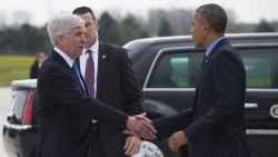 US President Barack Obama shakes hands with Michigan Governor Rick Snyder upon his arrival at Bishop International Airport in Flint, Michigan, May 4, 2016.