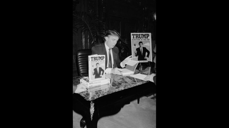 Trump signs his second book, "Trump: Surviving at the Top," in 1990. Trump <a href="index.php?page=&url=http%3A%2F%2Fwww.trump.com%2Fpublications%2F" target="_blank" target="_blank">has published</a> at least 16 other books, including "The Art of the Deal" and "The America We Deserve."
