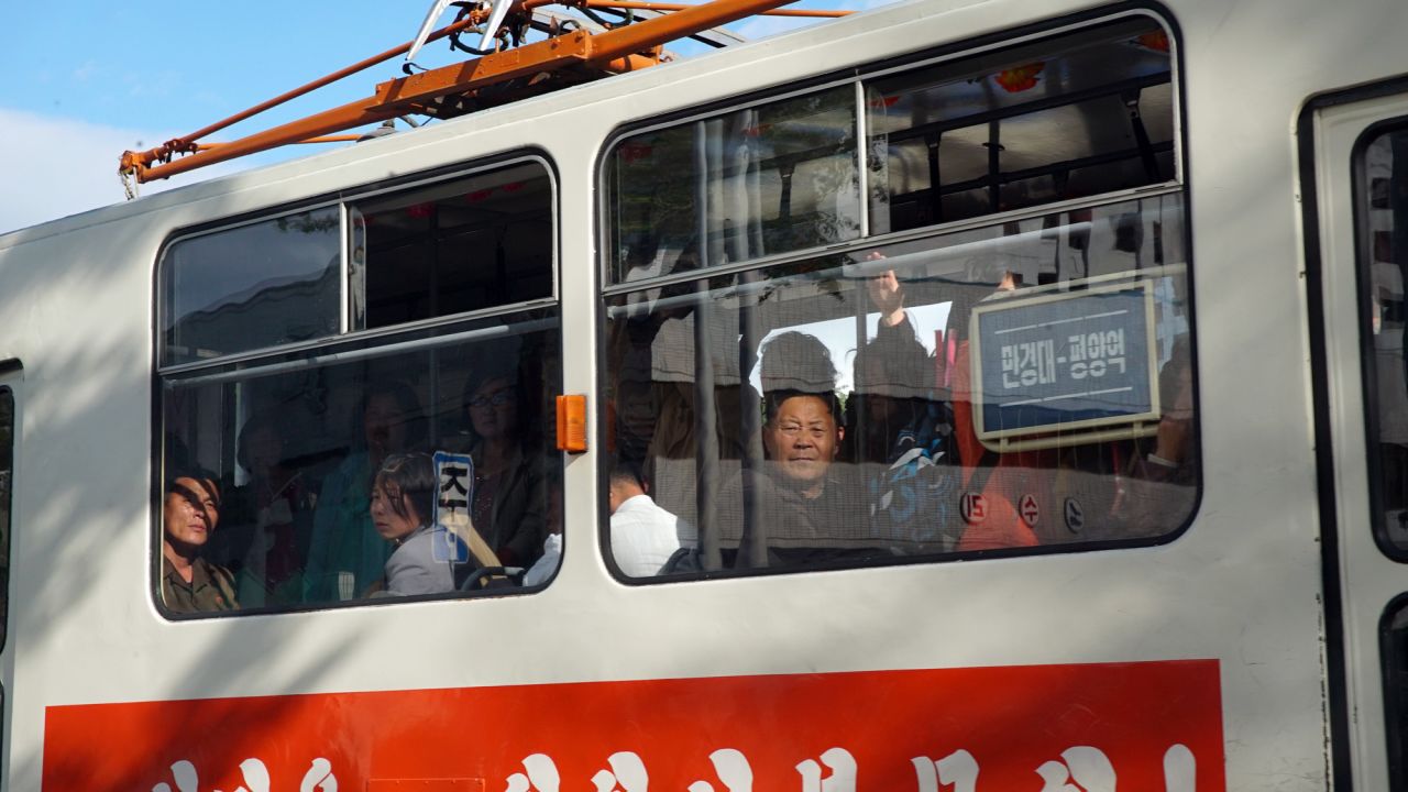 Passengers look curiously through the window at foreign journalists who are taking pictures of them on a tram in Pyongyang, May 4.