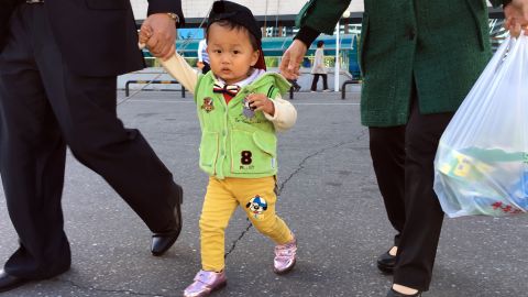 A growing number of Pyongyang's upper-middle class are able to purchase fashionable clothing, usually imported from China. Two-year-old Ri Ryong Won's mother is a primary school teacher.