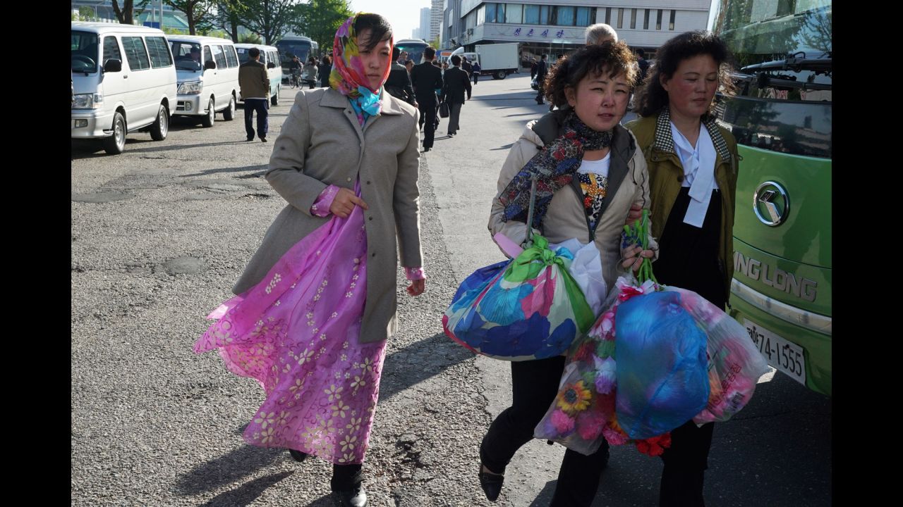 Everywhere you look people are carrying home bags of artificial flowers. They are standard issue for all major celebrations in North Korea.