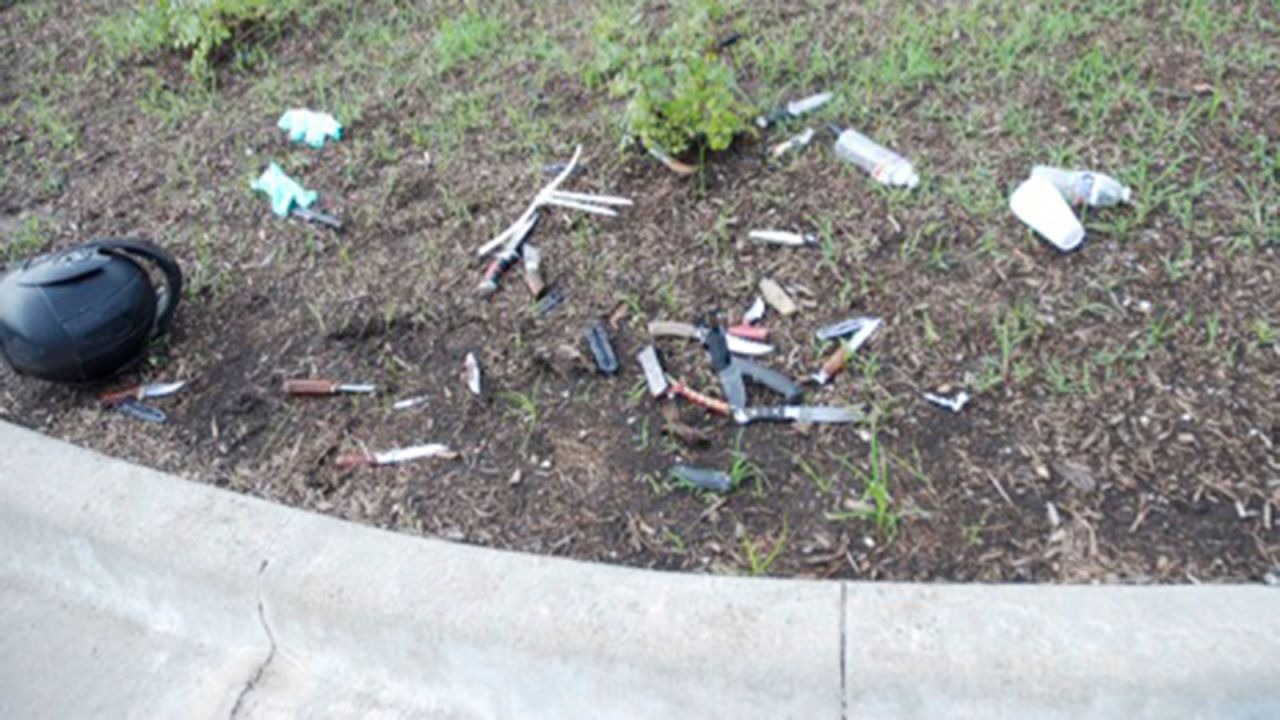 Knives and weapons are thrown across the dirt and weeds in the Twin Peaks parking lot.