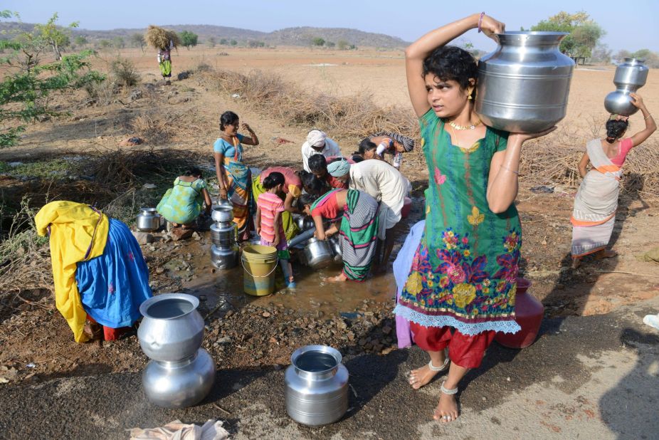 Villagers fill drinking water from a leaking roadside pipe in Nalgonda on April 25.