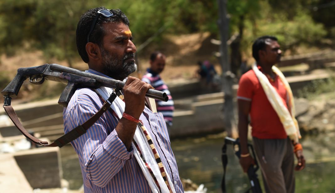 India was hit by the worst drought in decades in 2016. Here, gunmen stand alert at a water reservoir in Tikamgarh, India, on April 27.