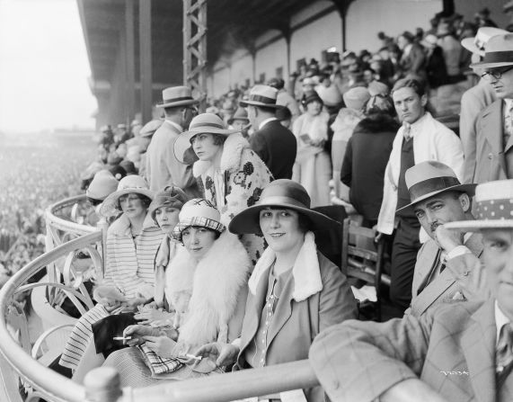 The Derby first launched in 1875, and up until the turn of the 20th century women could be seen wearing hats, gloves, and long dresses down to their ankles.<br />"At any social outing in America at that time, you would have worn a hat and gloves -- and the Kentucky Derby was no different," said Chris Goodlet, Curator of Collections at the <a href="index.php?page=&url=http%3A%2F%2Fwww.derbymuseum.org%2F" target="_blank" target="_blank">Kentucky Derby Museum.</a><br />"Many women would have worn silk because of the warm weather, and be carrying a parasol."<br />This image features race-goers in 1926.