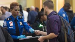 A TSA Agent checks the ID's of passengers as they pass through a security checkpoint on the way to their flights at Reagan National Airport in Arlington, Virginia, December 23, 2015. More than 100 million holiday travelers are expected to travel in the US during the last weeks of the year according to the American Automobile Association. AFP PHOTO / SAUL LOEB / AFP / SAUL LOEB        (Photo credit should read SAUL LOEB/AFP/Getty Images)