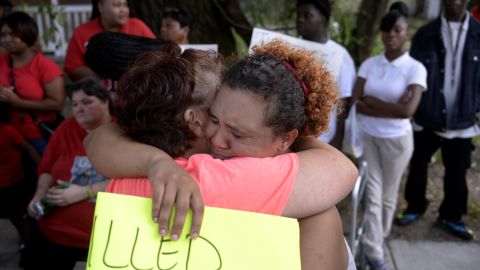 Martha Holmes, left, hugs Janie Smith, older sister of Charles Smith, who was shot and killed on Augusta Avenue by police in 2014.
