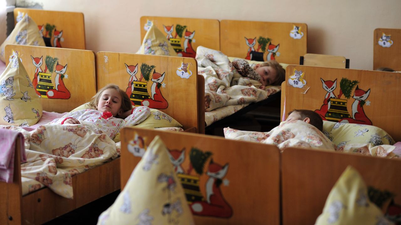 Children take their afternoon nap at Kindergarten 'Veselka' in Svitlodarsk, eastern Ukraine. The school was heavily damaged by shelling at the beginning of 2015, with children and teachers sheltering in the basement during the bombardment. 