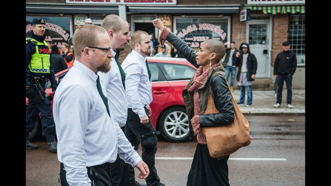 Tess Apslund, 42, stands with a raised fist in front of uniformed neo-Nazis during a Nordic Resistance Movement demonstration in Borlange, Sweden, on Sunday, May 1.