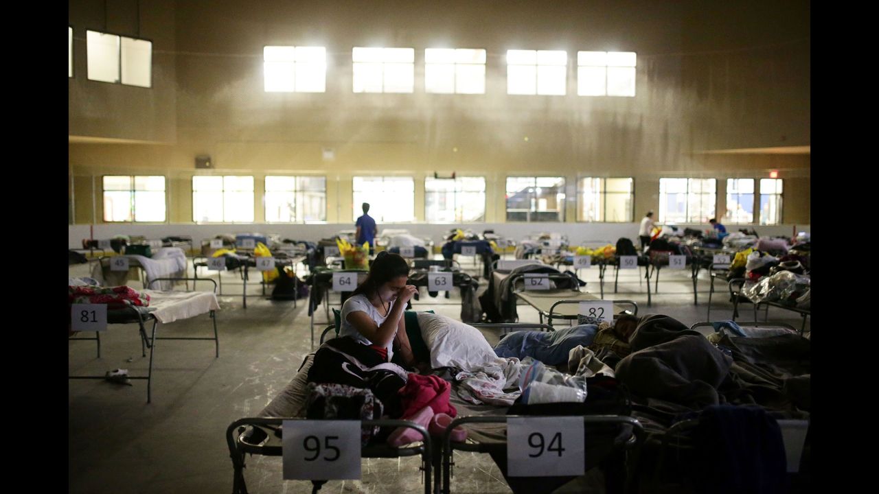 Tyra Abo sits on a cot at a makeshift evacuation center in Lac la Biche, Alberta, on May 5.