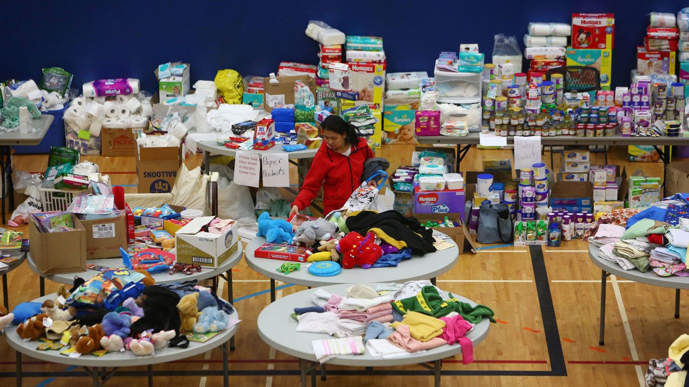 A woman picks through donated clothing and goods at a makeshift evacuation center in Lac la Biche on May 5.
