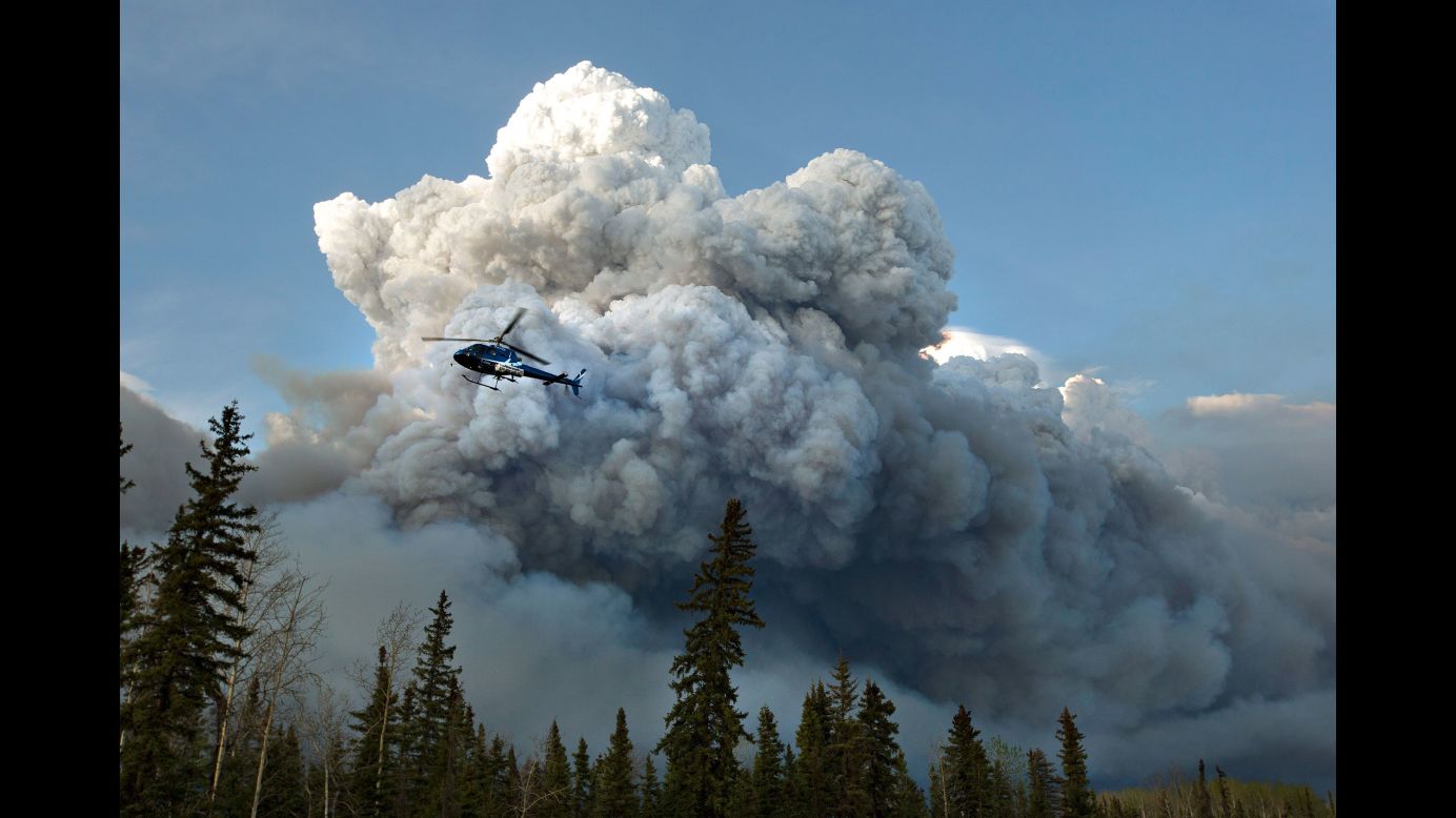 A helicopter flies past the wildfire in Fort McMurray on May 4.
