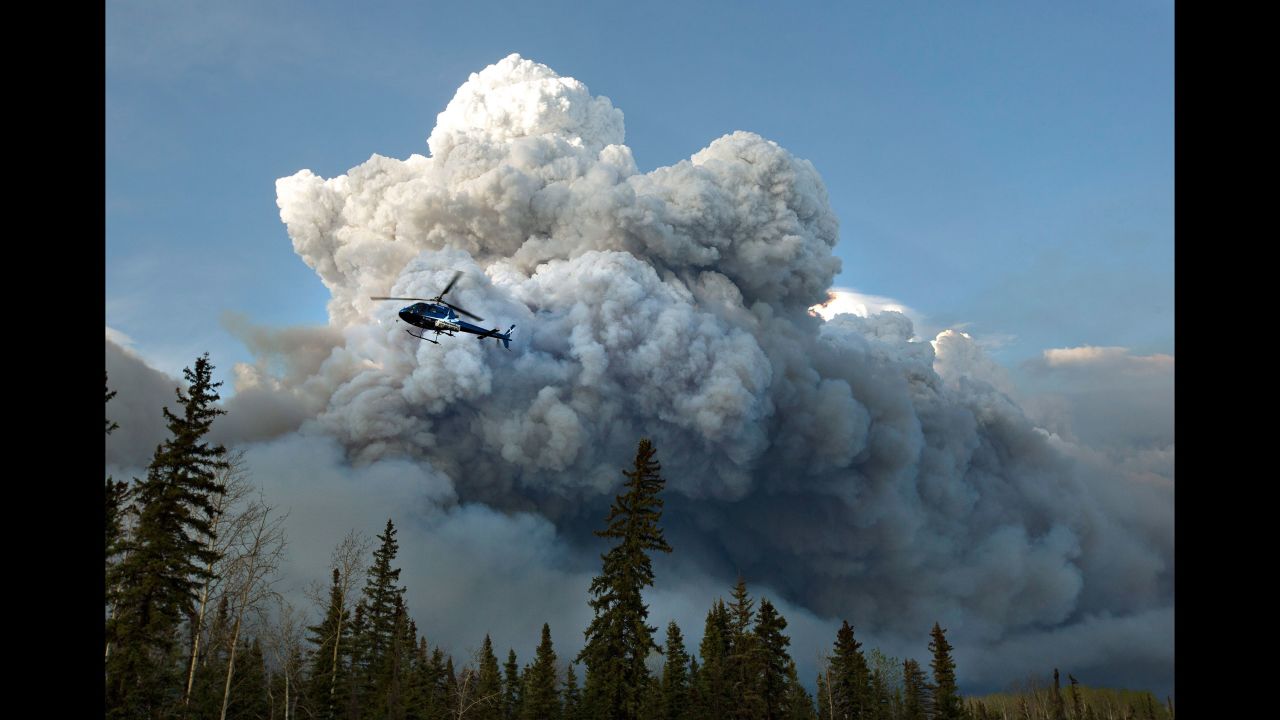 A helicopter flies past the wildfire in Fort McMurray on May 4.