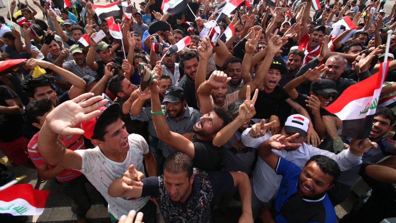 Iraqi protesters gather in the parade grounds outside the parliament in Baghdad's heavily fortified "Green Zone" on May 1, 2016, a day after supporters of Shiite cleric Moqtada al-Sadr broke into the area after lawmakers again failed to approve new ministers.
Protesters were withdrawing from Baghdad's Green Zone after breaking into the fortified area and storming Iraq's parliament in an unprecedented security breach the day before. The move, which lessens the pressure on politicians in Baghdad, came as rare bombings in the south killed 33 people and wounded dozens. / AFP / HAIDAR MOHAMMED ALI        (Photo credit should read HAIDAR MOHAMMED ALI/AFP/Getty Images)