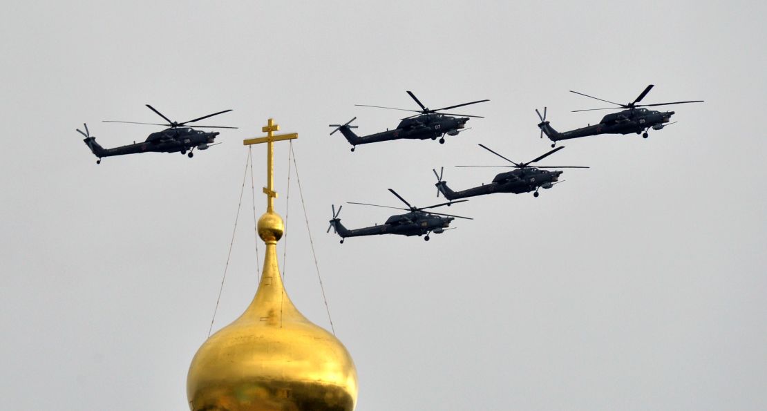 Russian Mil Mi-28 helicopter gunships fly above the Kremlin's cathedrals in Moscow, on May 7, 2014.