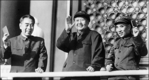 China's leaders during the Cultural Revolution: Premier Zhou Enlai, Chairman Mao Zedong and Defense Minister Lin Biao wave during a military parade on Tiananmen Square. 