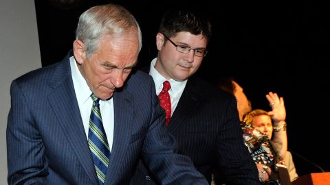 Rep. Ron Paul, R-Texas, signs the back of a large copy of the United States Constitution for supporter Walter Zdazinsky as Paul's campaign manager, Jesse Benton, looks on at the Silverton Casino Lodge in Las Vegas, Nevada, on May 17, 2011.