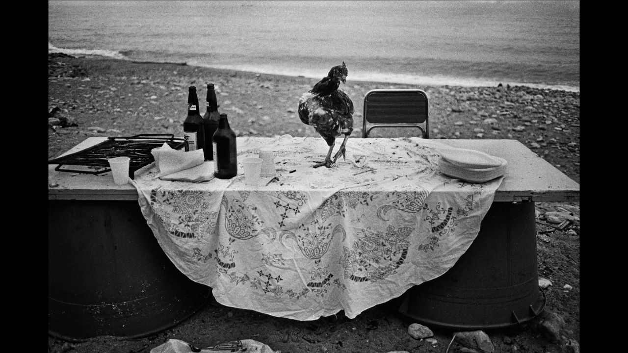 The picture from 1986 is one of Battaglia's favorites. "I went to the seaside to shoot something, and I saw this very strange table. Someone had organized a party on the seaside and I don't know why, but all that was left was this hen. It's poetic. I am looking for poetry in life. That's all I need."