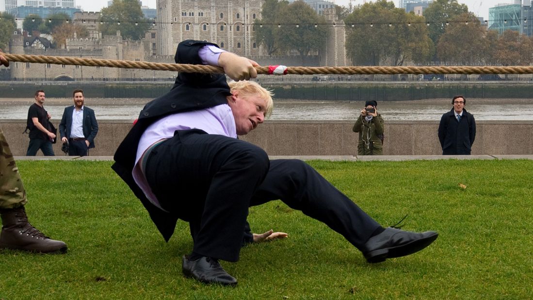 Johnson falls while competing in a tug of war October 27, 2015, during the launch of London Poppy Day.