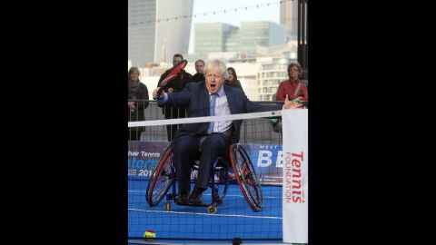 Johnson plays wheelchair tennis to promote a tournament in London on November 24, 2014.