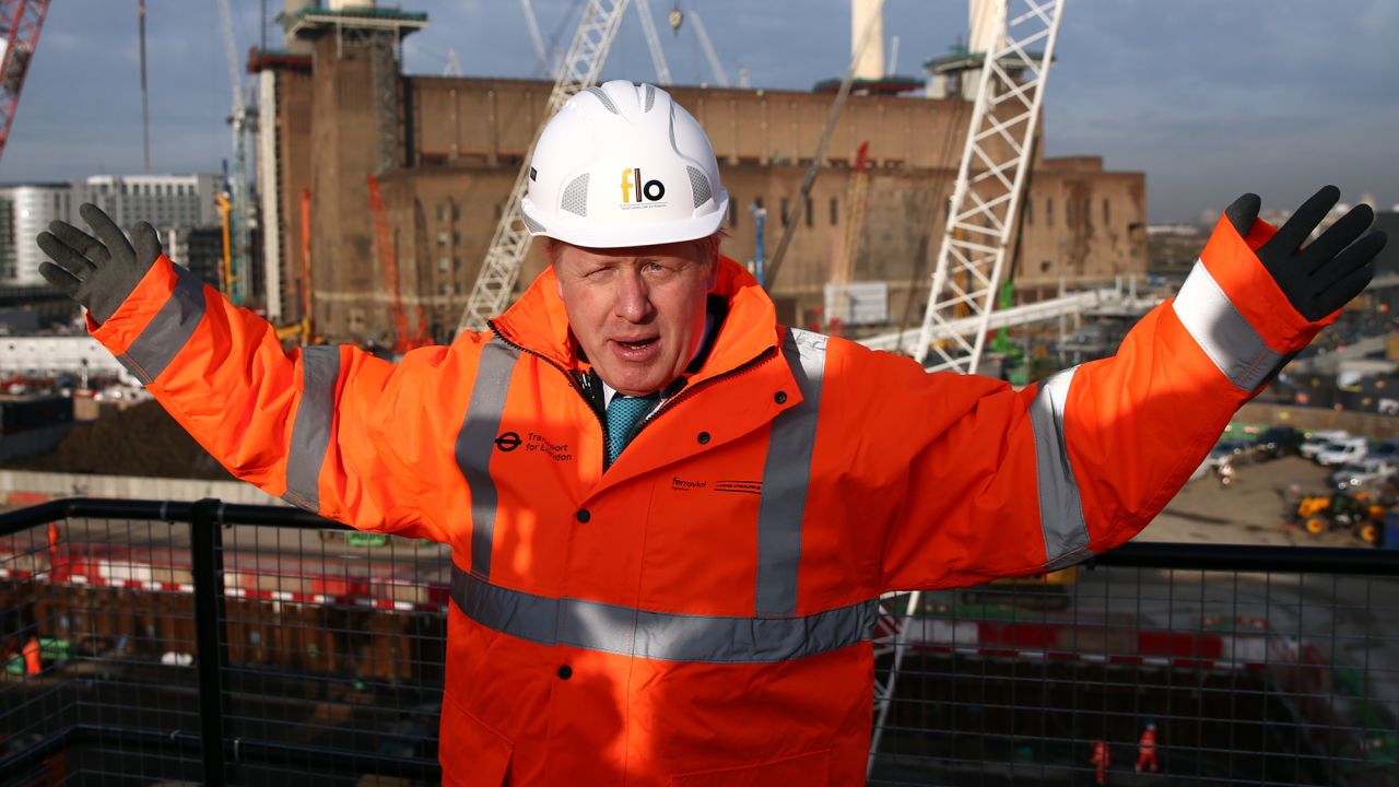 Johnson poses for a photograph to mark the start of a London Underground extension on November 23, 2015.