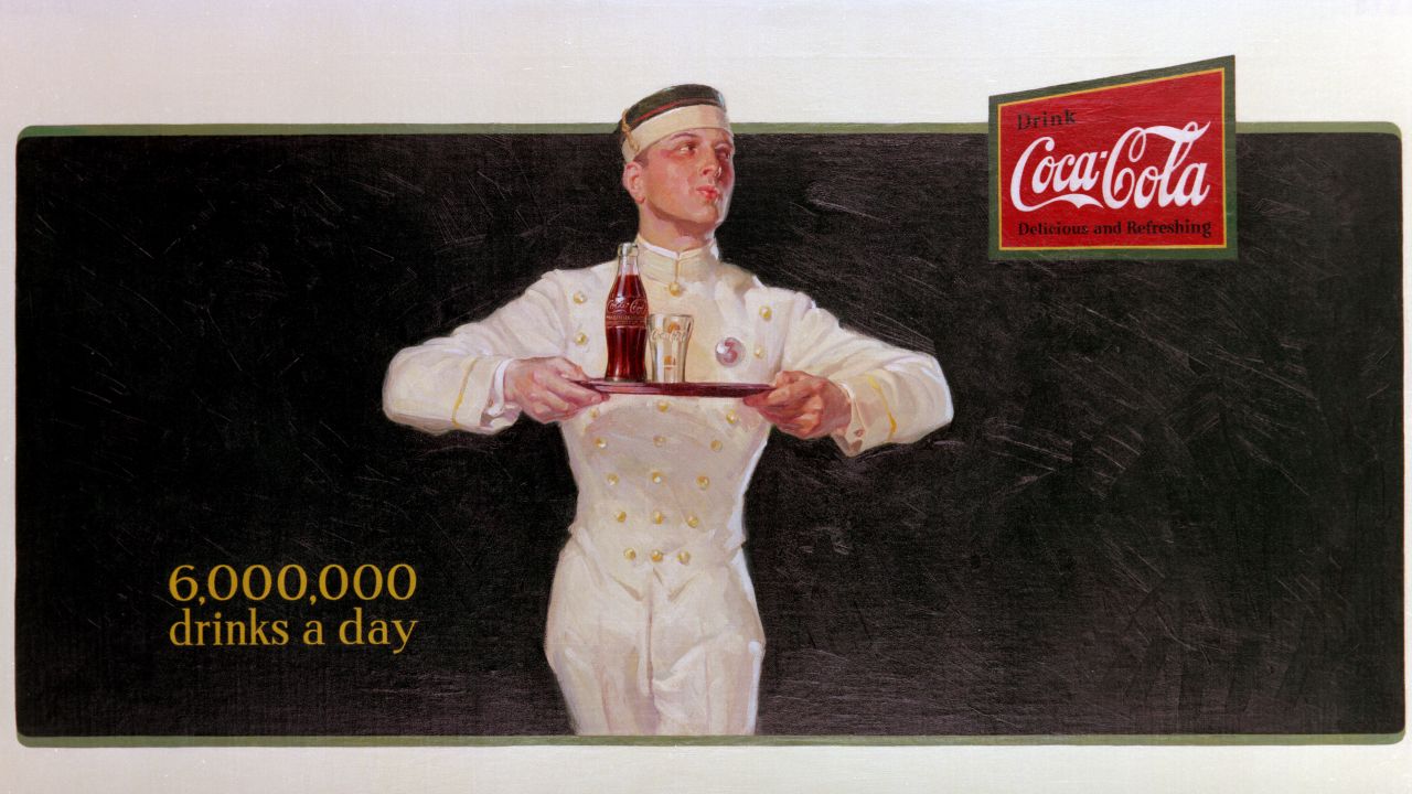 <strong>1925:</strong> Coca-Cola's first billboard, "Ritz Boy," promotes how popular the drink had become.