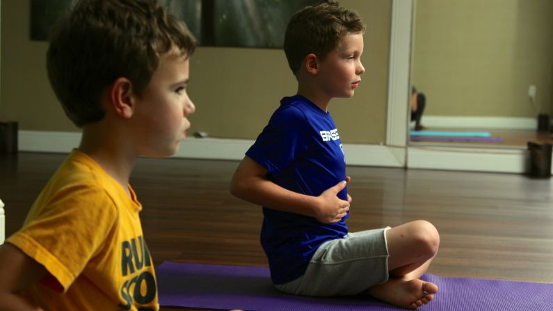 The boys work on their breathing technique. "Rib riding" reinforces proper breathing biomechanics.