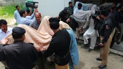 Pakistani police escort suspects accused of killing and setting fire to a woman as they arrive at a court in Abbottabad on May 5, 2016. 

A Pakistani woman was drugged, strangled and then her body set ablaze because she helped her friend elope, police said May 5, announcing the arrest of 14 people in a twist on the grim practice of "honour killings". / AFP PHOTO / SHAKEEL AHMEDSHAKEEL AHMED/AFP/Getty Images