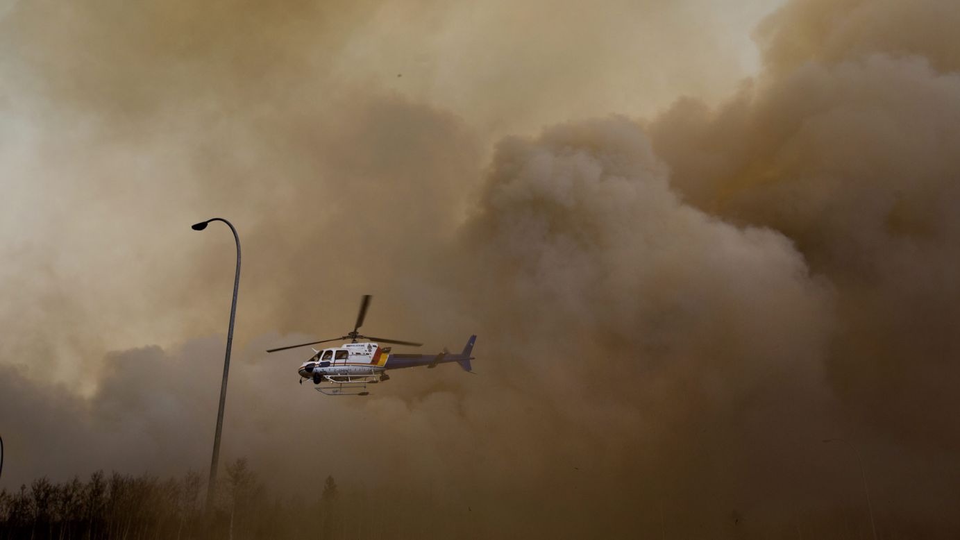 A police helicopter lifts off through dust and smoke on May 6. 
