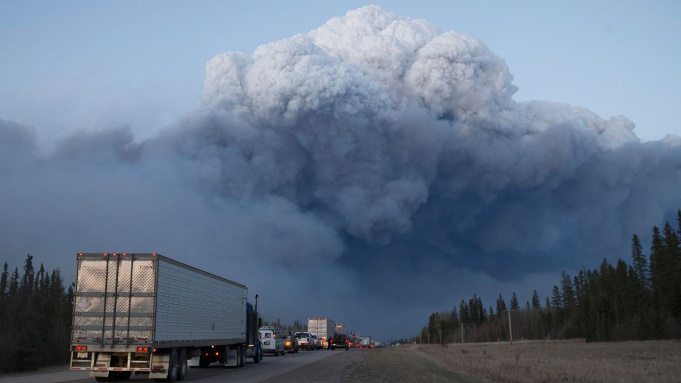 Drivers wait for clearance to take firefighting supplies into town on Thursday, May 5, outside Fort McMurray. 