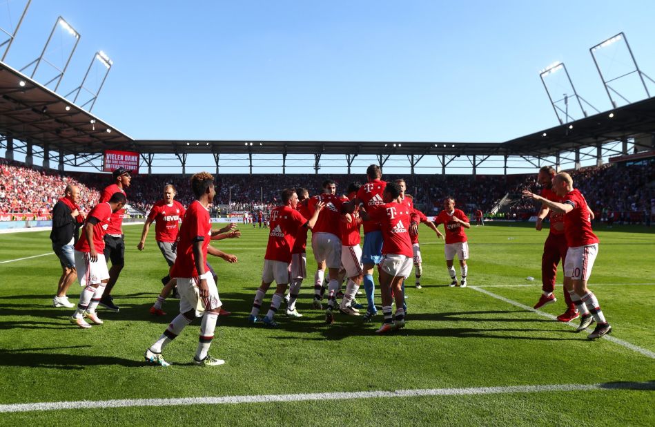 Bayern players celebrate their league triumph on the pitch after the full-time whistle.