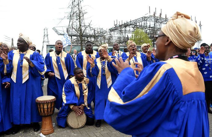 Members of a choir sing outside the King Power Stadium before the match.