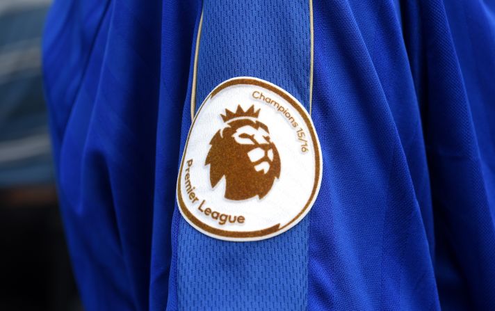 A newly minted Premier League Champions badge adorns a Leicester fan's shirt.