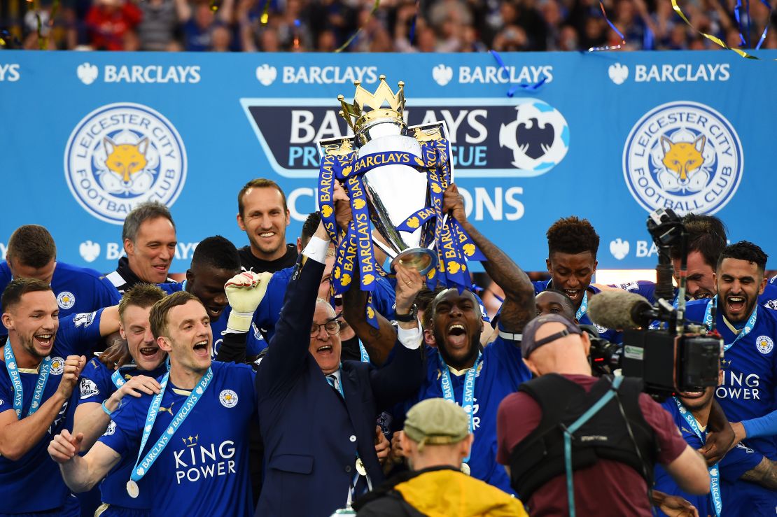 Captain Wes Morgan and manager Claudio Ranieri of Leicester City lift the Premier League trophy.