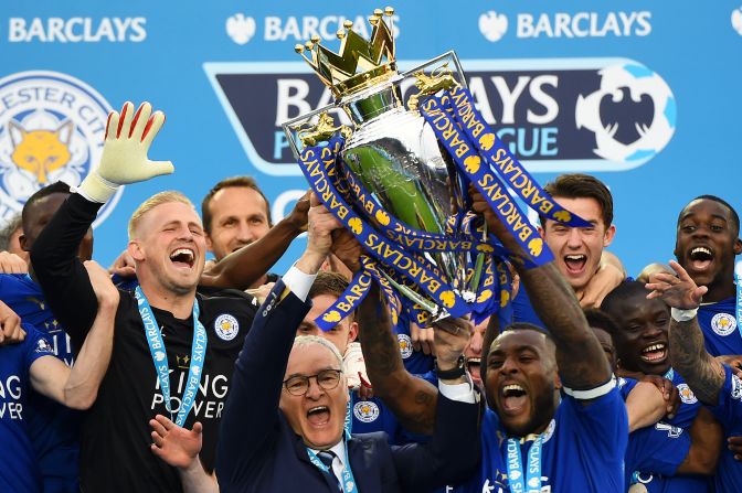 Captain Wes Morgan and manager Claudio Ranieri of Leicester City lift the Premier League trophy after defeating Everton 3-1.