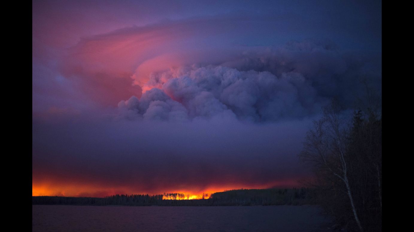 Smoke and flames create a dramatic sunset near Fort McMurray on Friday, May 6.
