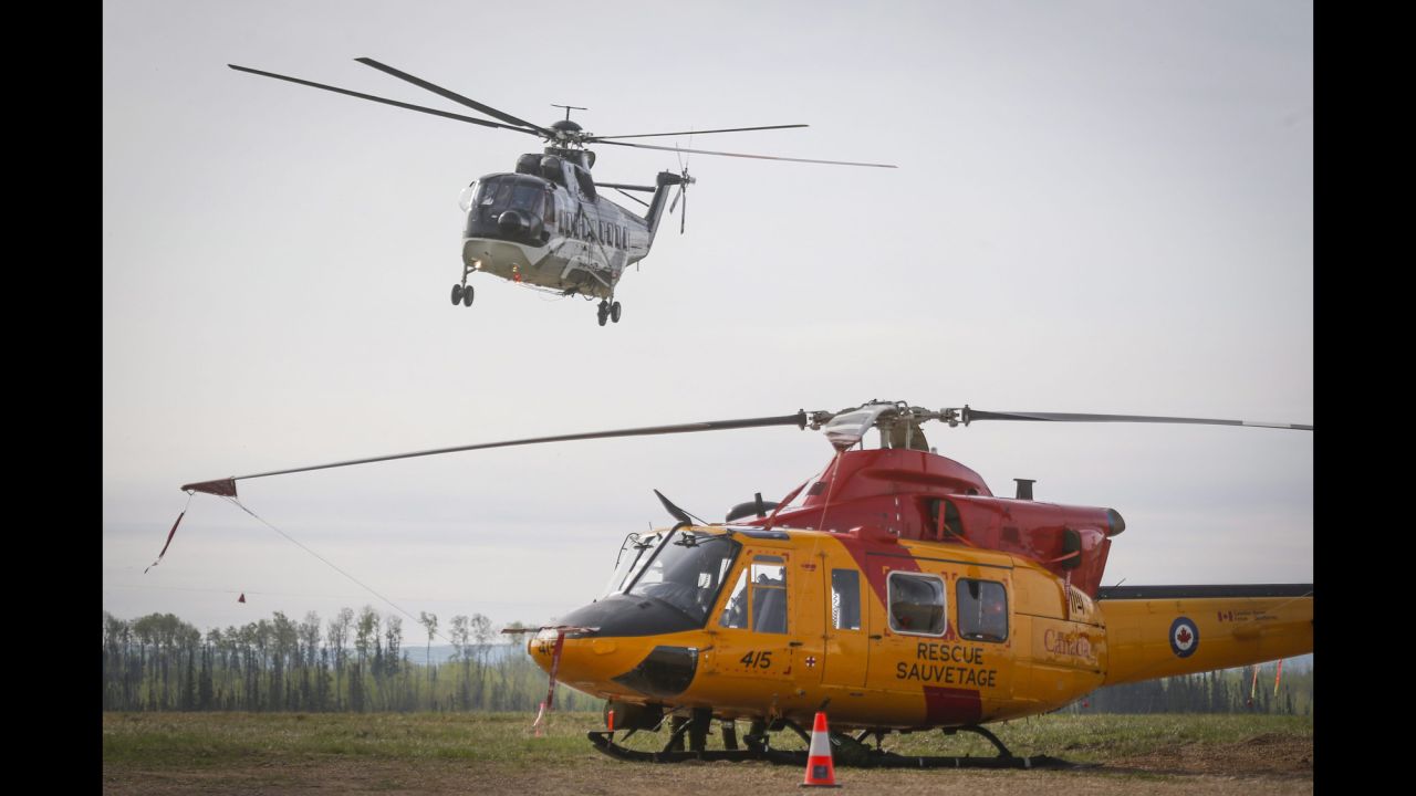 A helicopter helping with the Fort McMurray wildfire takes off from a staging base near Conklin, Alberta, on May 7.